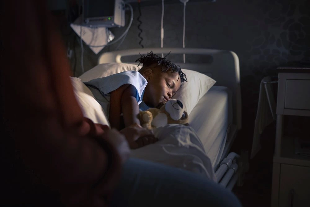 a photo of a child in a hospital bed